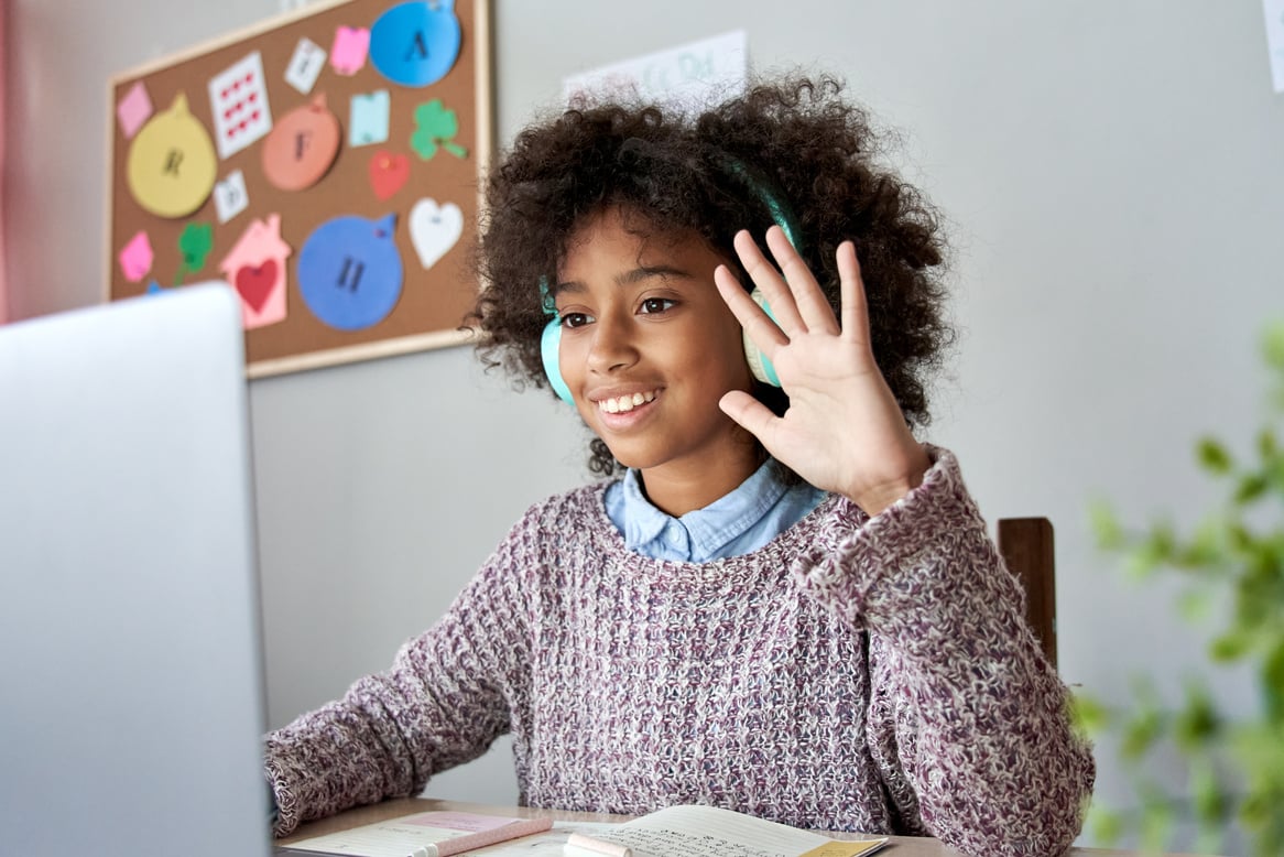 African Kid Girl Waving Hand Video Call Remote Learning on Laptop Computer.